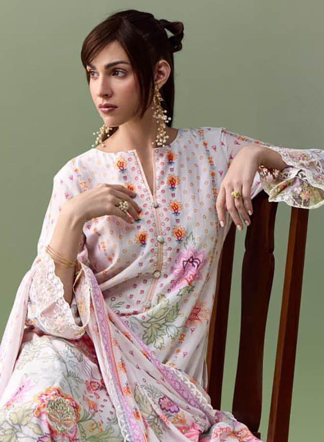Woman wearing pure muslin embroidered unstitched suit dress material with matching dupatta